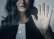 Image d'une femme tendant la main avec un geste de stop, symbolisant la lutte contre le harcèlement moral - Axia Consultants
